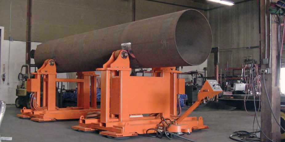 An air caster vehicle featuring a synchronous guide wheel mechanism to rotate a 40’ cylinder used to build larger heat exchangers