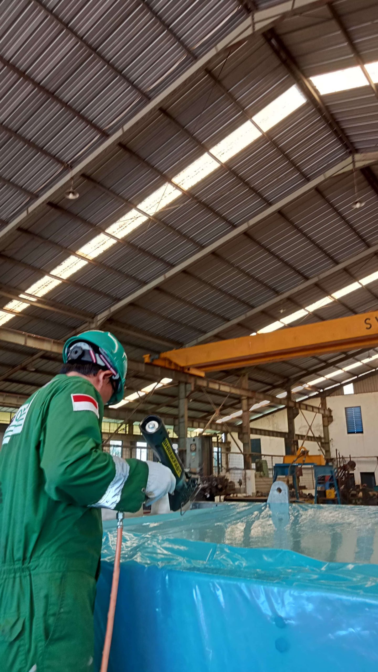 Shrink wrapping heat exchanger with corrosion inhibiting film. Image courtesy of Tiga Ombak, Cortec® Case History 852