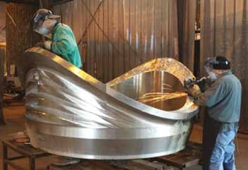 Within WFI International, two operators are putting the final touches on a 72 NPS Sweepolet® made of 304 stainless steel. This product is an integrally reinforced branch connection which restores full strength to the pipe in which it is installed.
