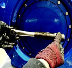 tightening bolts on a valve