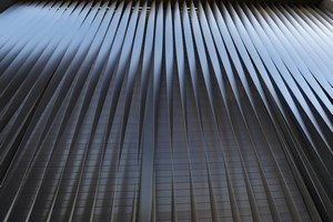 Each vertical titanium blade is torqued to a specific point and locked in place with steel bolts into a steel exterior frame.