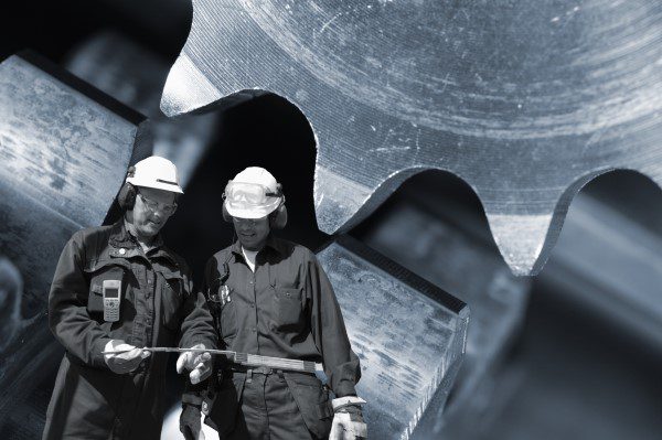 two-industry-workers-with-machine-parts_rtMn5XRNo