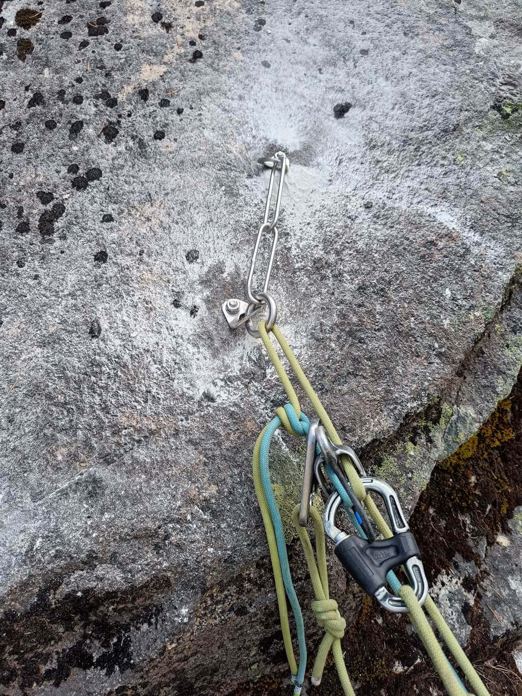 Belay stations with stainless steel rings or carbine hooks provide a point to transfer the rope and allow climbers to descend from the freshly restored and expended climbing crag in the Gotthard Massif. Image: Max Foss.