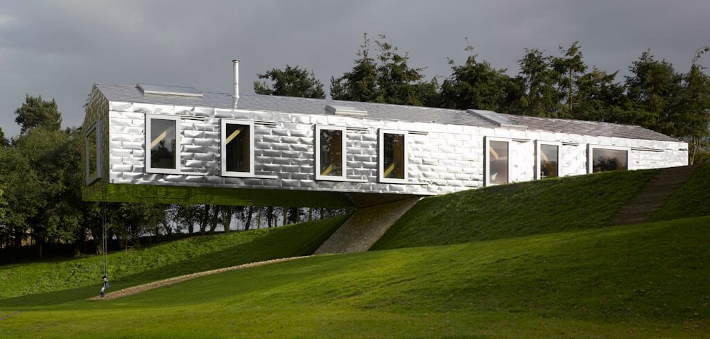 The aptly named Balancing Barn, from Mole Architects, is clad in Ugi Bright stainless steel (type 316) from Arcelor Mittal. It is located by a small lake in the English countryside. Photo: © Edmund Sumner. Courtesy of MVRDV and Living Architecture.