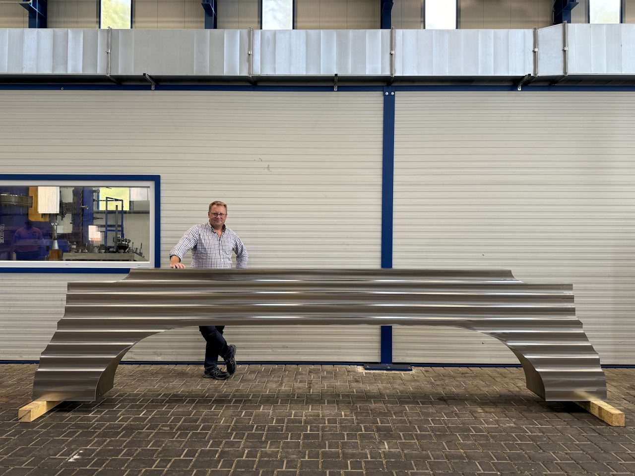 Markus Kind with a large stainless steel forging for a fusion machine magnet production. Photo courtesy of Rolf Kind.