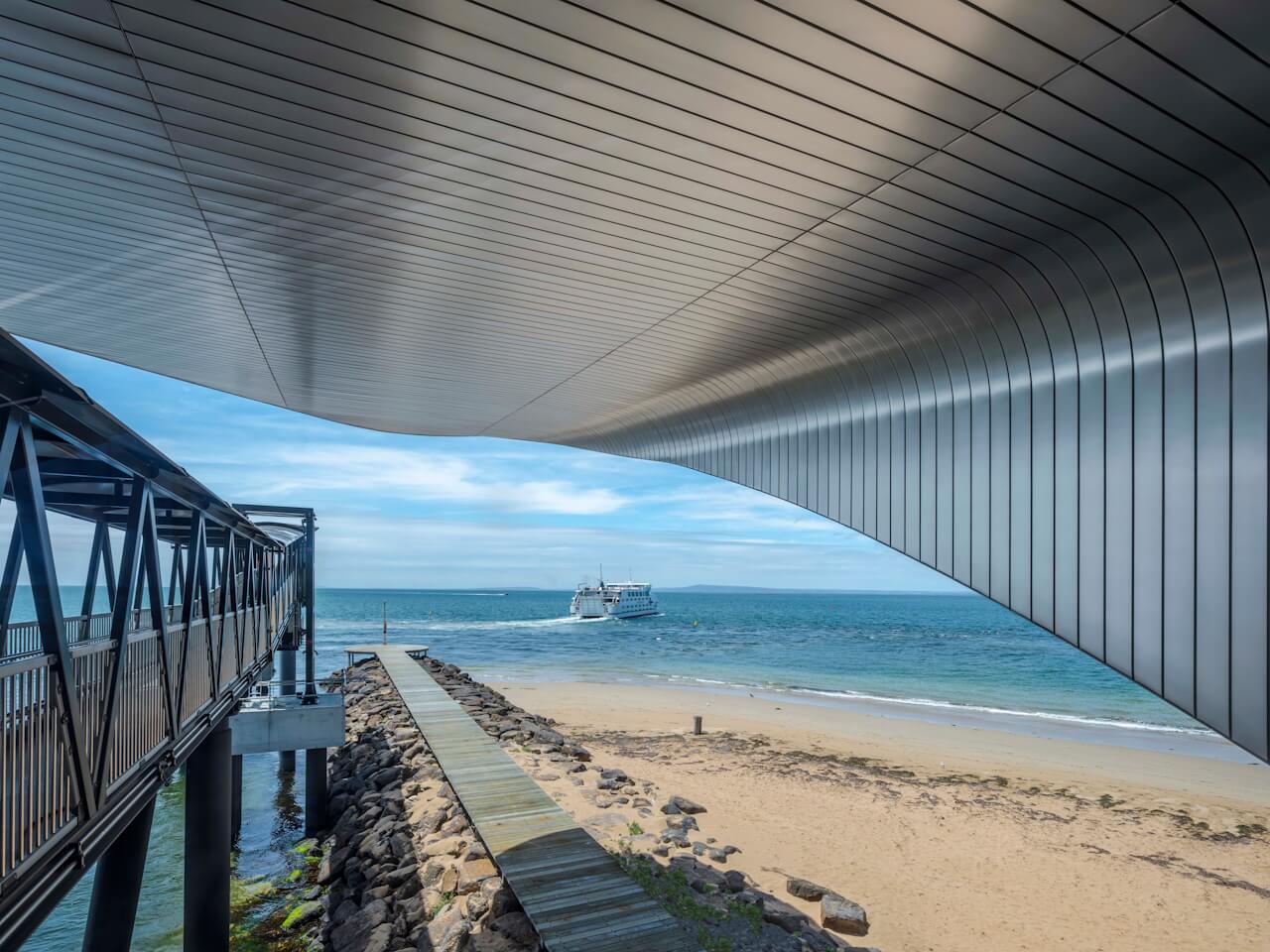 The roof stretches gracefully with a nod to the curved profile of this unique stretch of coastline. ©Tim Griffith. All rights reserved.